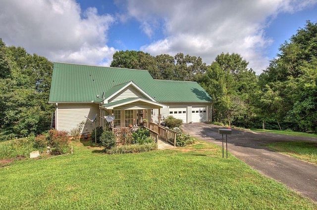 view of front facade with covered porch, a front yard, and a garage