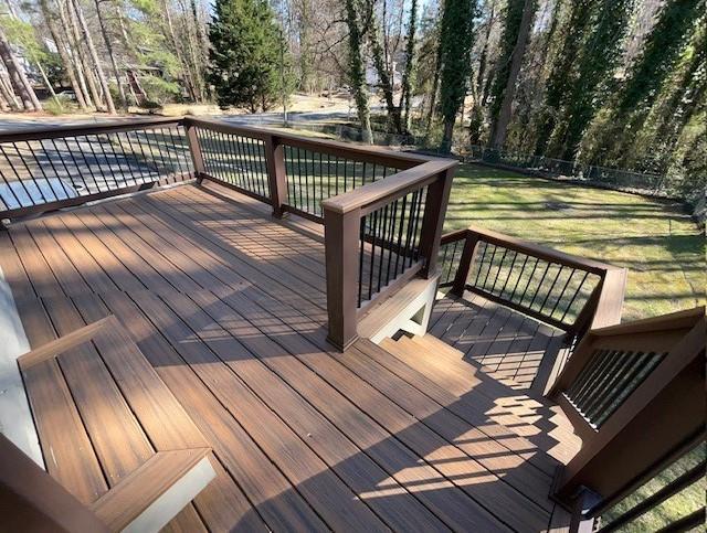 wooden deck featuring a yard