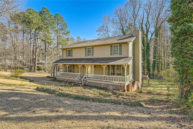 view of front of home featuring a porch and a chimney