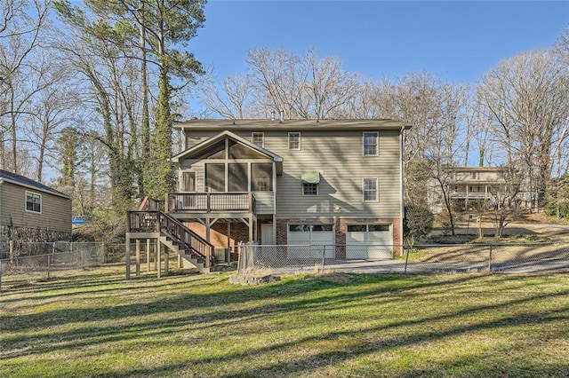 back of property with fence, driveway, a lawn, stairway, and a wooden deck