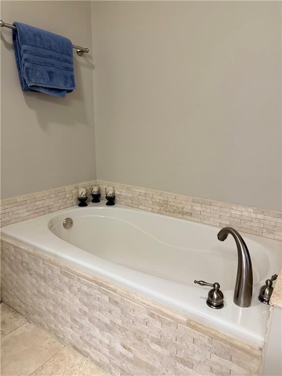 full bathroom featuring a bath and tile patterned floors