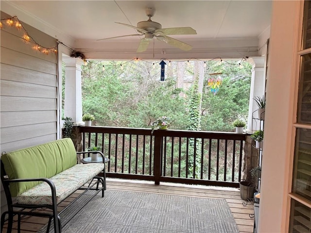 wooden deck with a ceiling fan