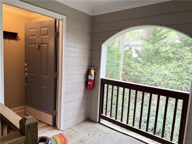 view of exterior entry with a balcony