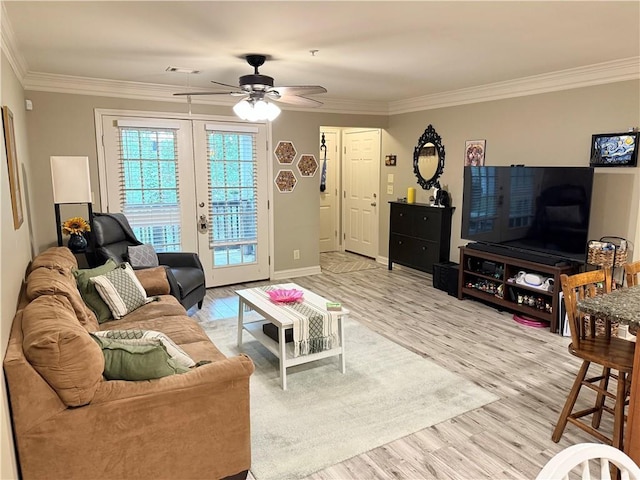 living area featuring a ceiling fan, visible vents, ornamental molding, and wood finished floors