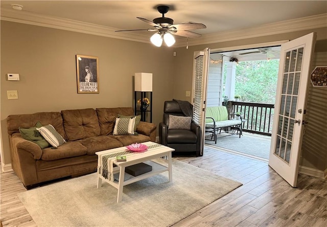 living area with light wood-type flooring, crown molding, ceiling fan, and french doors