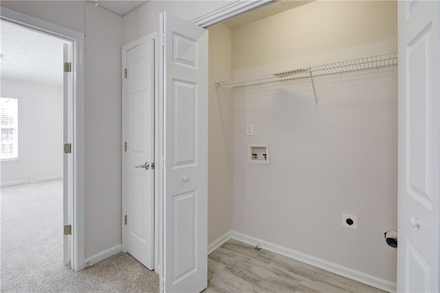 laundry area with washer hookup, light colored carpet, electric dryer hookup, laundry area, and baseboards