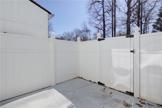 view of patio featuring a gate and fence