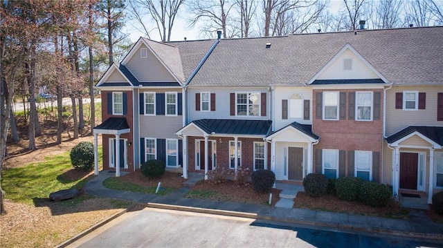 townhome / multi-family property featuring brick siding