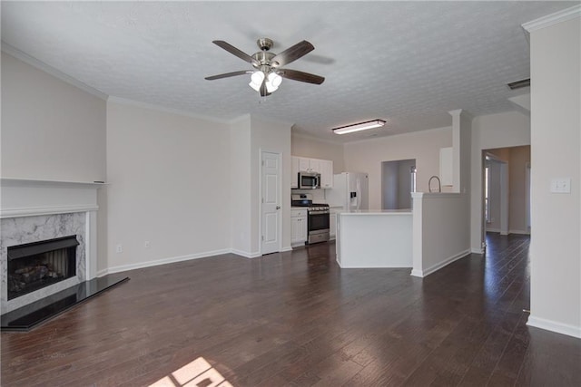 unfurnished living room featuring dark wood finished floors, a textured ceiling, and a premium fireplace