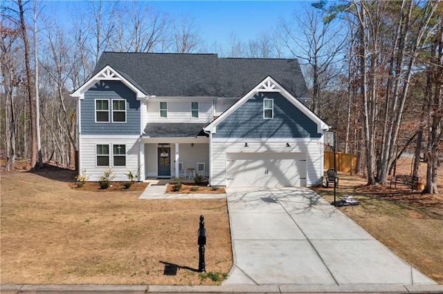 view of front of house featuring an attached garage, driveway, a front lawn, and a porch