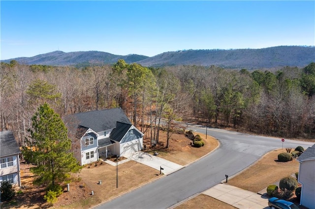 birds eye view of property featuring a forest view and a mountain view