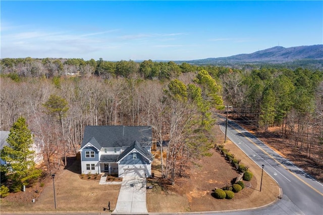 birds eye view of property with a wooded view