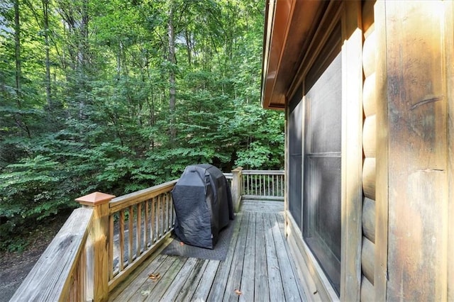 wooden terrace with a grill