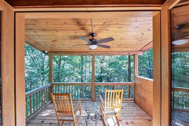 wooden deck featuring ceiling fan