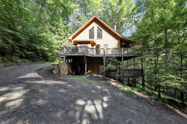 view of side of property featuring a wooden deck