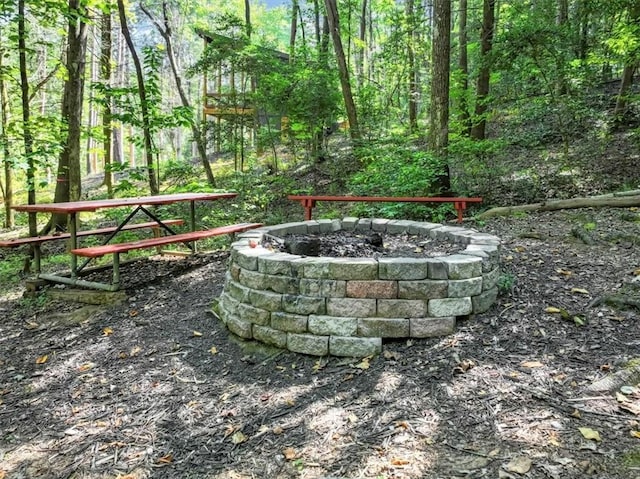 view of home's community with an outdoor fire pit