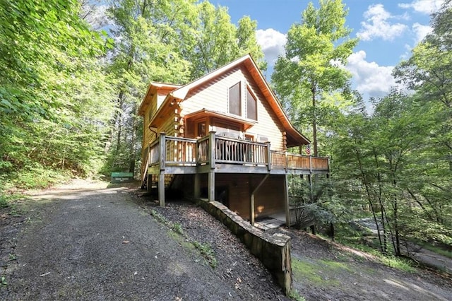 back of property featuring a wooden deck