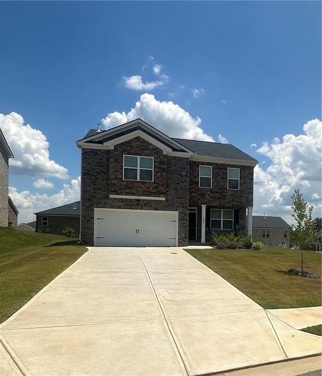 view of front of house with a front lawn and a garage