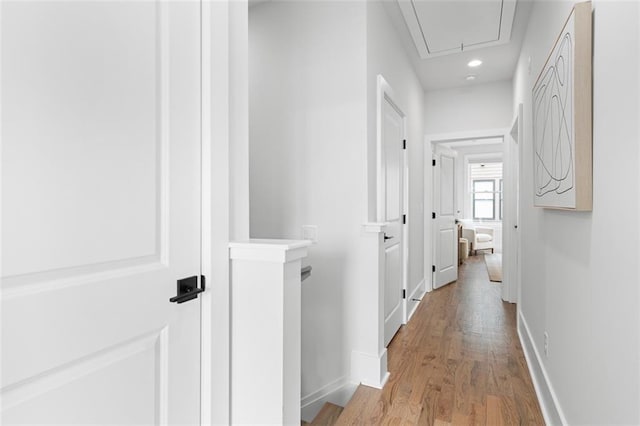 hallway with light hardwood / wood-style floors