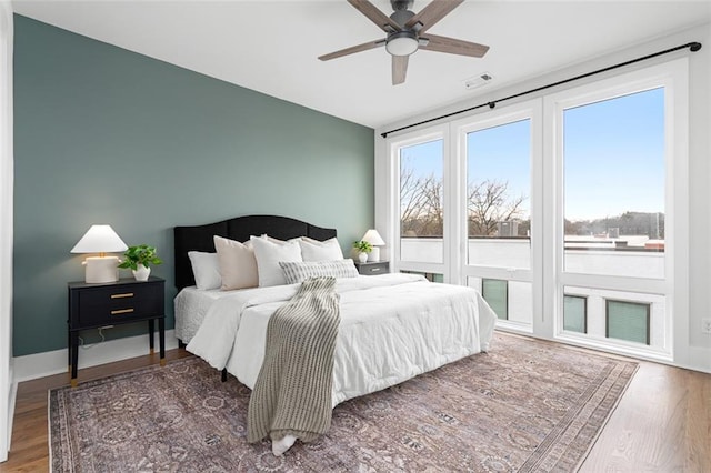 bedroom with ceiling fan and dark hardwood / wood-style flooring