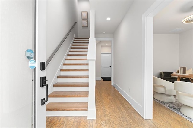 stairway featuring wood-type flooring