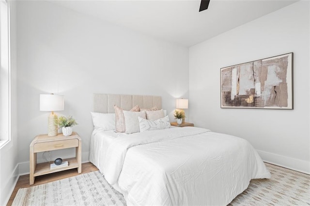 bedroom with ceiling fan and light hardwood / wood-style floors