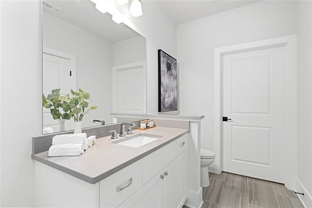 bathroom with vanity and toilet