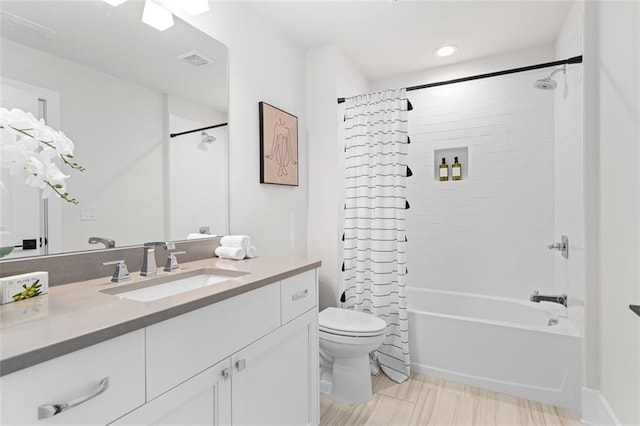 full bathroom with vanity, shower / bath combination with curtain, and toilet