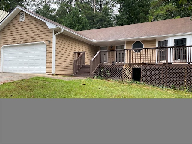 single story home with a front lawn, a deck, and a garage