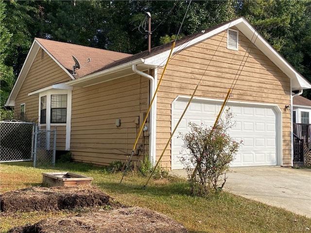 view of side of home featuring a yard and a garage