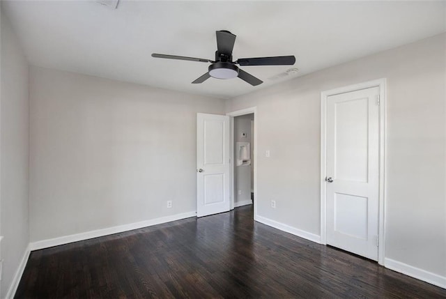 3060 Washington Rd, Atlanta, GA 30344 - unfurnished bedroom with dark wood-style flooring, baseboards, and ceiling fan