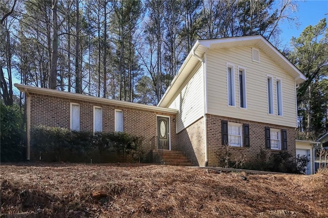 view of front of house with entry steps and brick siding