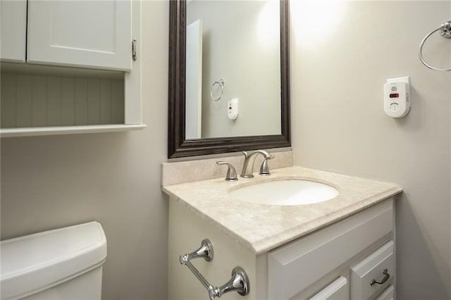 bathroom featuring toilet and vanity