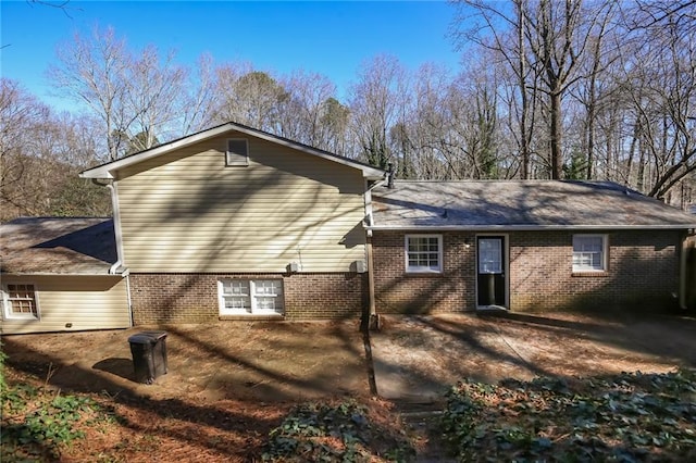 rear view of property with brick siding