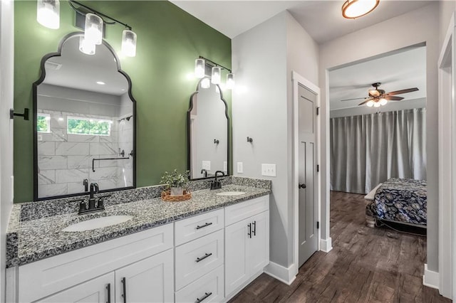 bathroom featuring vanity, hardwood / wood-style flooring, ceiling fan, and walk in shower