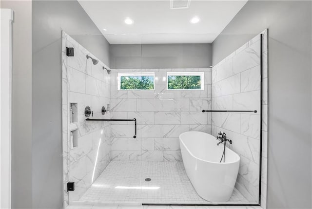 bathroom with separate shower and tub