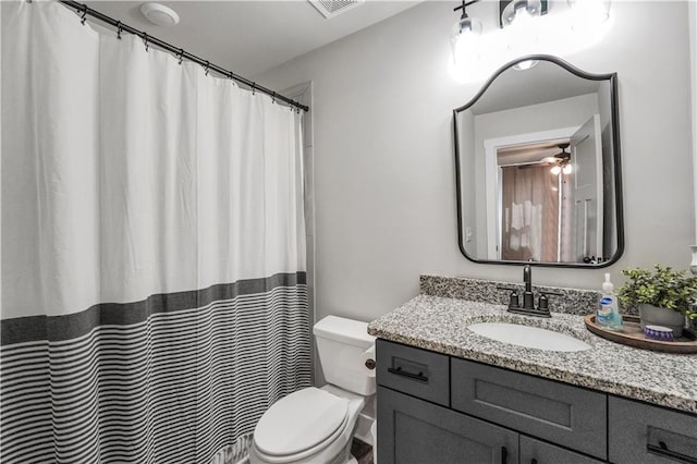 bathroom with vanity, ceiling fan, and toilet