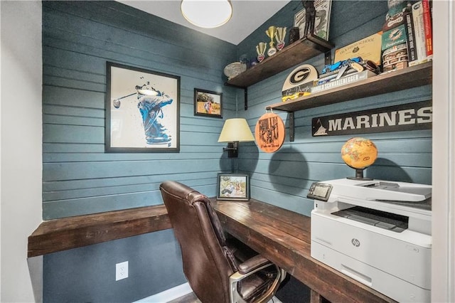 office area featuring wood walls