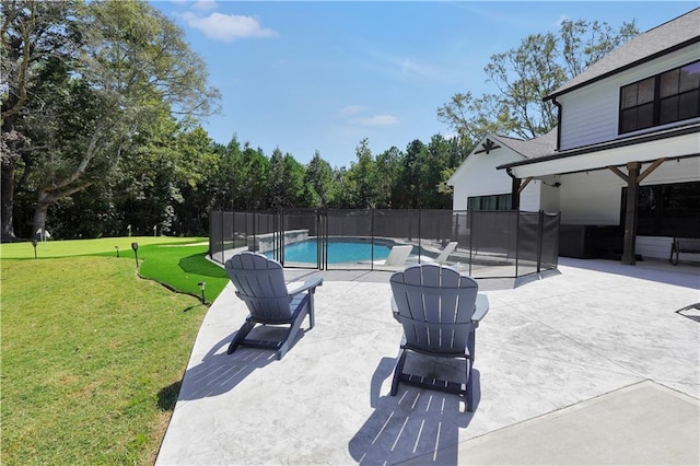 view of swimming pool with a patio and a lawn