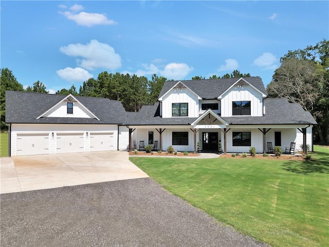 modern farmhouse style home with a garage, a front yard, and covered porch