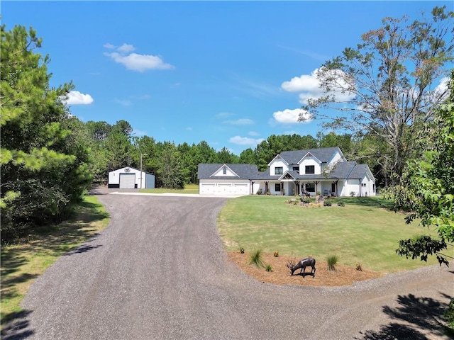 view of front facade featuring a garage, an outdoor structure, and a front lawn