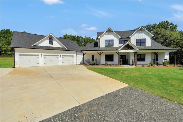 modern farmhouse featuring a garage and a front lawn