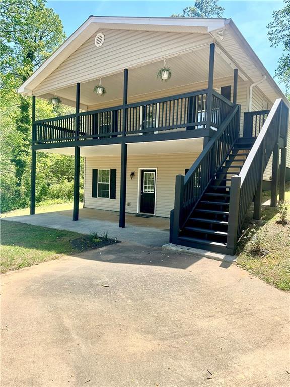 exterior space featuring driveway and stairs