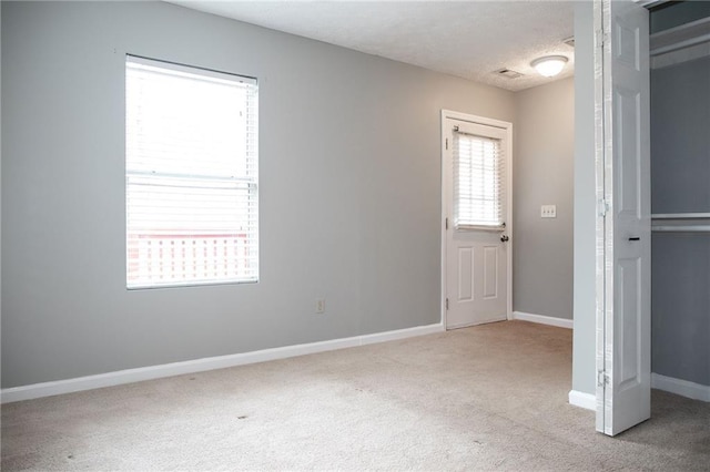 interior space with baseboards, carpet, and a textured ceiling