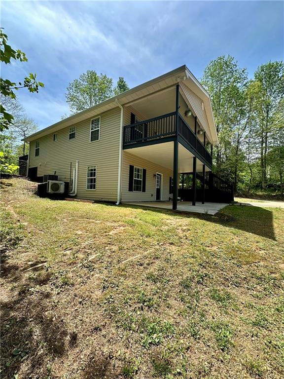back of property with a patio area and a lawn