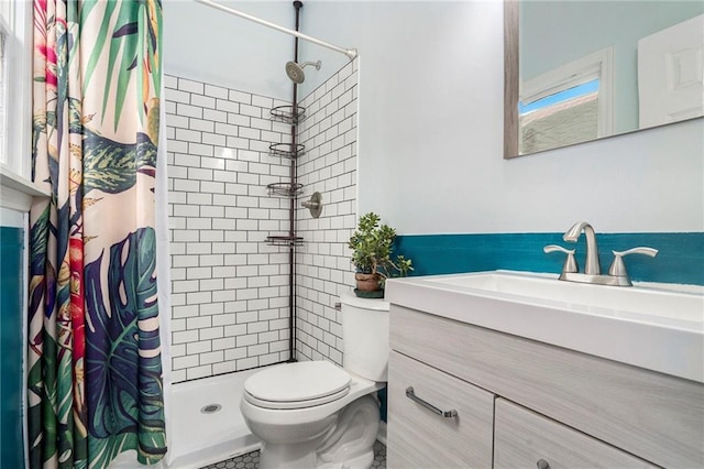 bathroom with curtained shower, vanity, and toilet