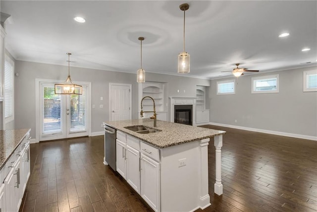 4204 Hardy Ave, Smyrna, GA 30082 - kitchen featuring a sink, stainless steel dishwasher, a ceiling fan, crown molding, and a glass covered fireplace