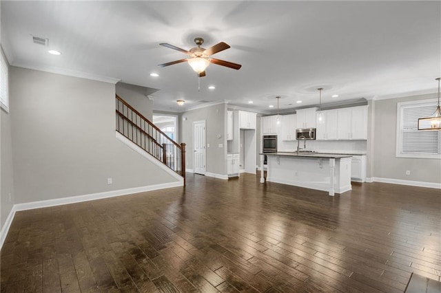 4204 Hardy Ave, Smyrna, GA 30082 - unfurnished living room featuring a ceiling fan, ornamental molding, dark wood-style flooring, baseboards, and recessed lighting