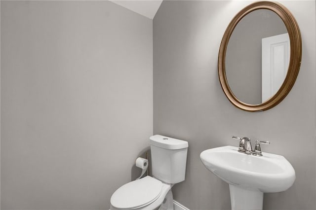 4204 Hardy Ave, Smyrna, GA 30082 - bathroom featuring toilet, baseboards, and a sink