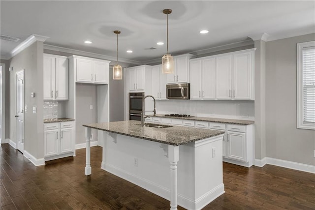 4204 Hardy Ave, Smyrna, GA 30082 - kitchen featuring stainless steel appliances, a sink, baseboards, an island with sink, and white cabinets